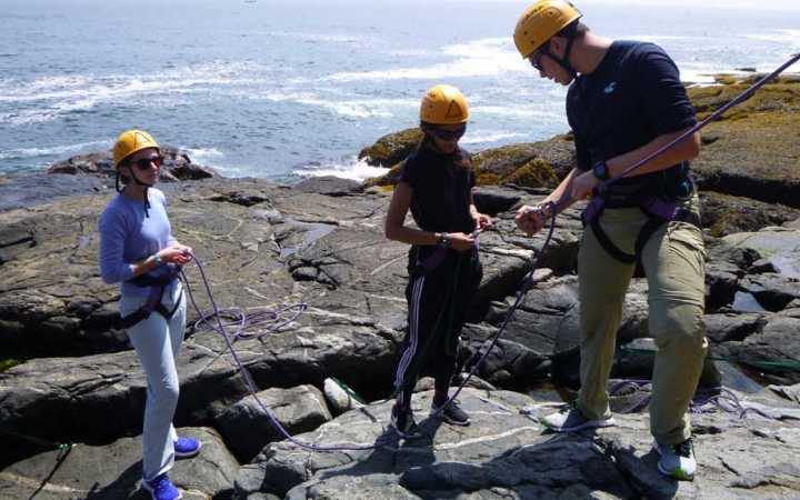 adults unplug during rock climbing class in maine